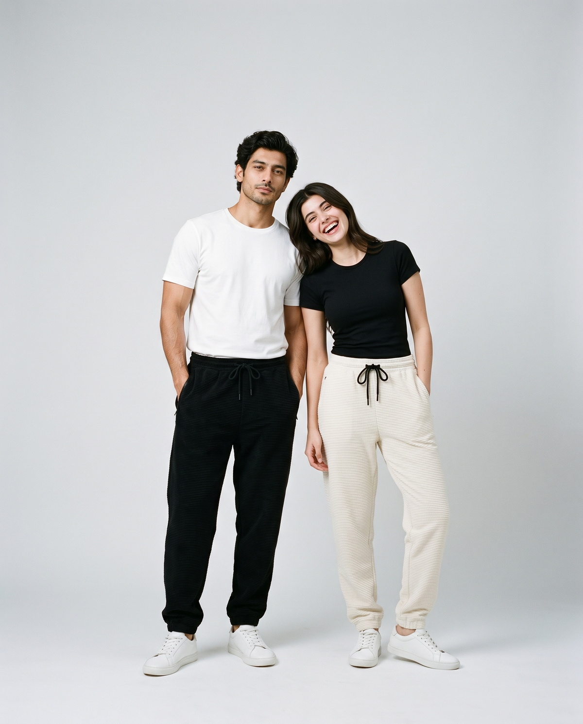 Candid studio duo wearing black and ivory ribbed corduroy trousers